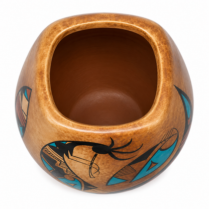 A handcrafted brown ceramic pot with a square opening, decorated with black and turquoise geometric patterns on a white background.